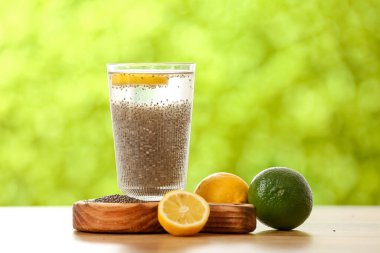 Yemek, bir bardak çim tohumlu su ve açık havada turunçgil meyvesi.