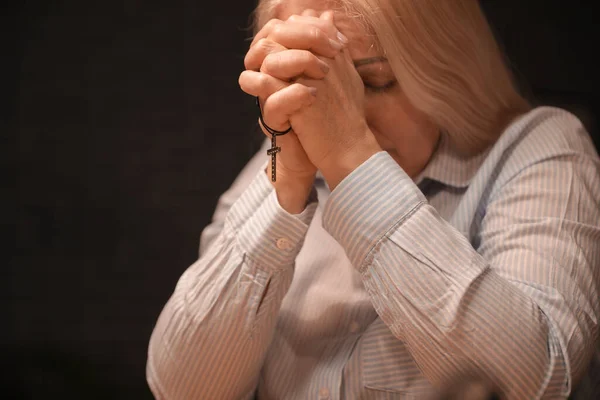 Praying Mature Woman Cross Dark Background — Stok fotoğraf