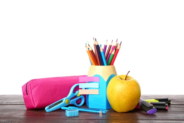 School stationery with apple on wooden table against white background