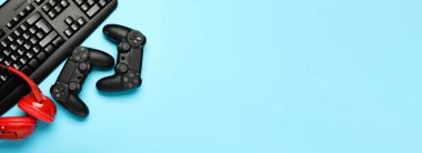 Modern gaming accessories on blue background with space for text