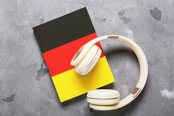 Modern Headphones Book Grey Background Concept Studying German Language — Stock Photo, Image