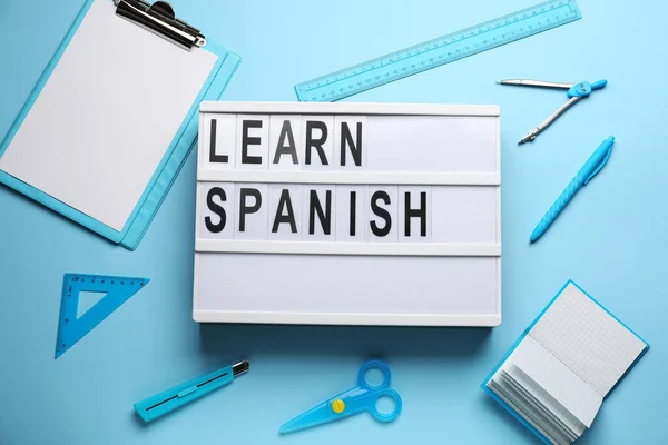 Board Text Learn Spanish Stationery Light Blue Background Top View — Stock Photo, Image