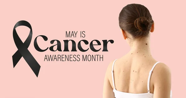 Young woman with moles, black ribbon and text MAY IS CANCER AWARENESS MONTH on pink background