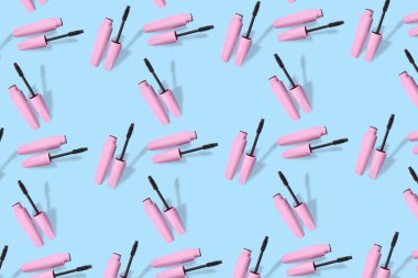 Black mascara on blue background. Pattern for design