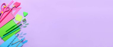 Many school stationery on lilac background with space for text, top view