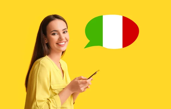 Beautiful Young Woman Smartphone Speech Bubble Yellow Background Studying Italian — Stockfoto