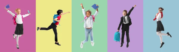 Group Jumping Little School Children Color Background — Stockfoto