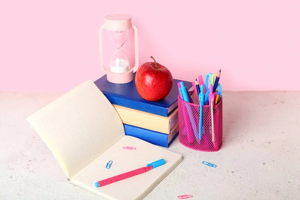 School Stationery Apple Hourglass Table Pink Background — Stok fotoğraf