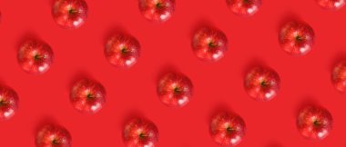 Fresh apples on red background. Pattern for design
