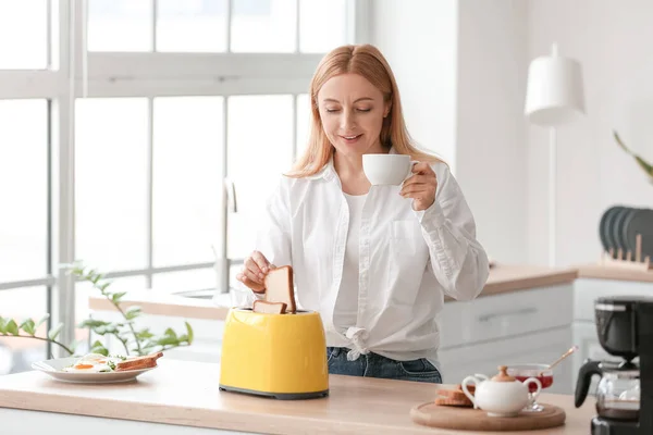 Mature Woman Making Tasty Toasts Drinking Coffee Kitchen — Stockfoto