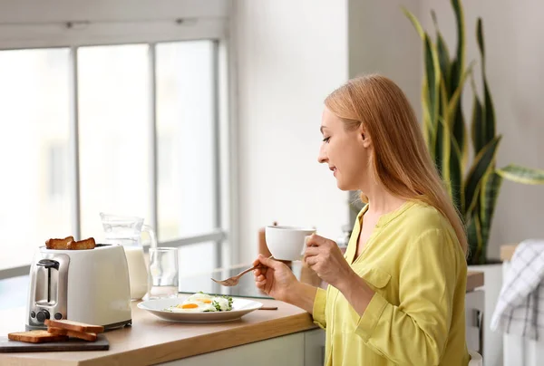 Mature Woman Eating Tasty Toasts Drinking Coffee Kitchen — Stock Photo, Image