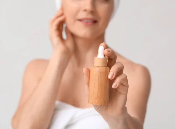 Mature Woman Cosmetic Serum Light Background Closeup — Stockfoto