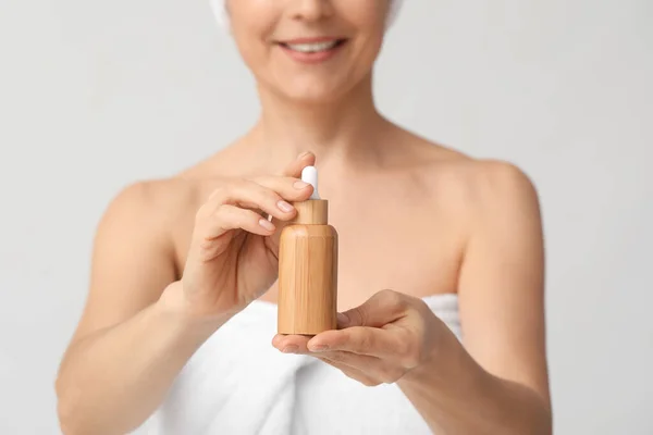 Mature Woman Cosmetic Serum Light Background Closeup — Stockfoto