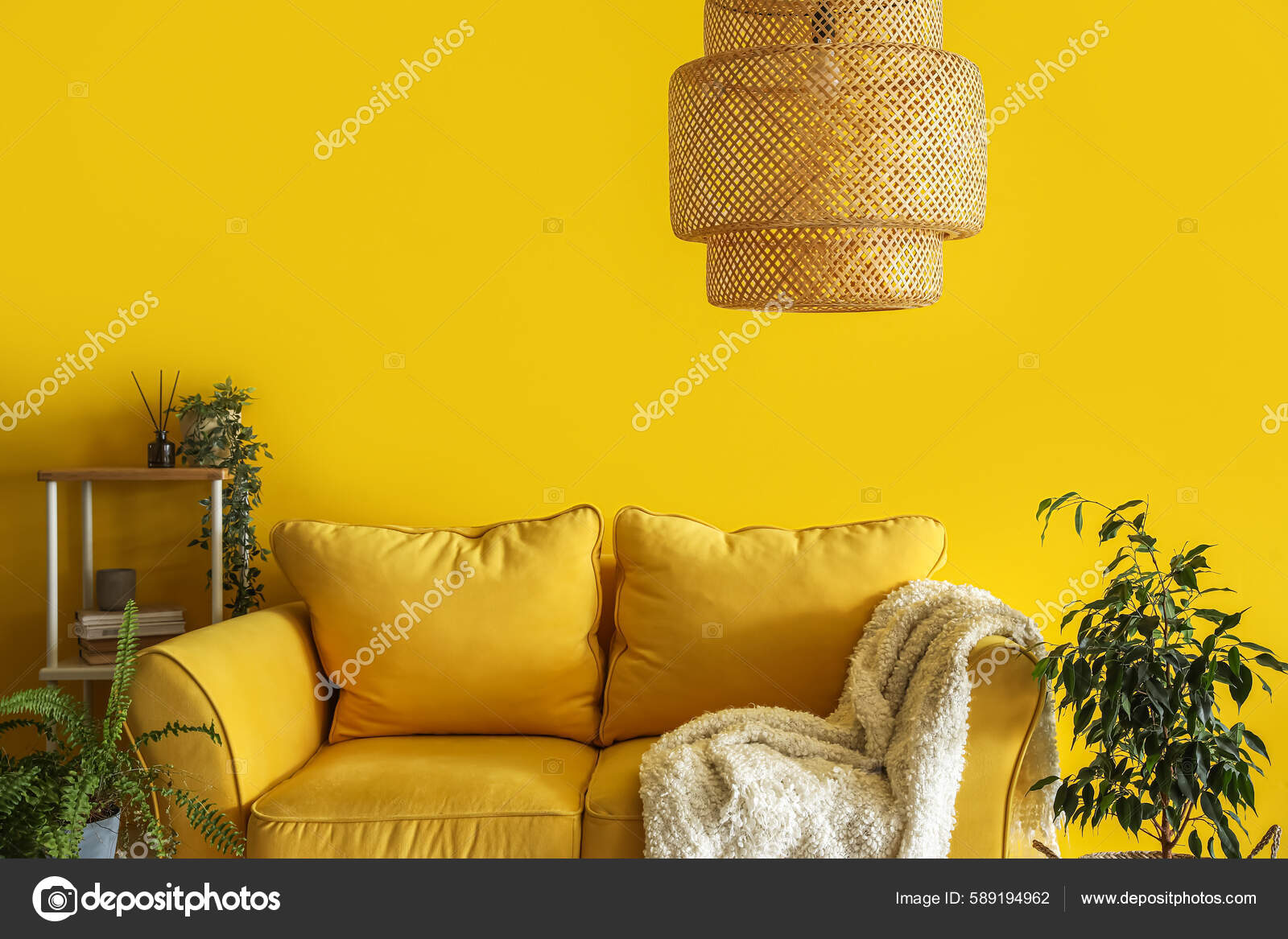 Comfortable Couch Shelving Unit Houseplants Yellow Wall Stock Photo by