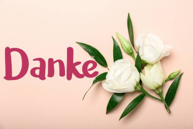 Pembe arka planda güzel çiçekler ve kelime DANKE (Almanca Teşekkür)