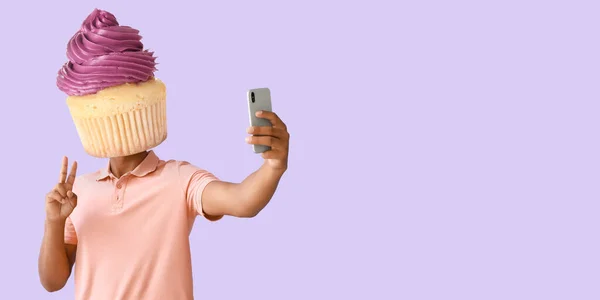 Man Sweet Cupcake Instead His Head Taking Selfie Lilac Background — Φωτογραφία Αρχείου