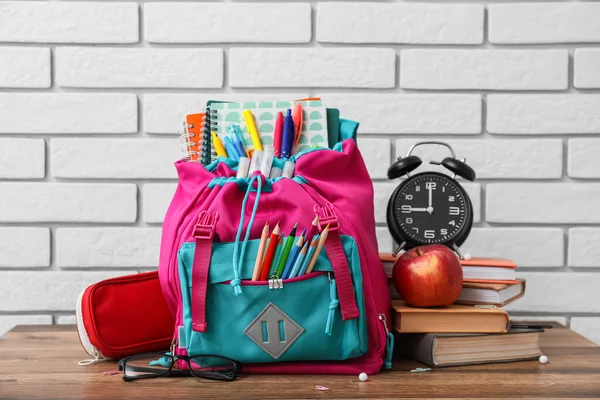 School Backpack Stationery Apple Alarm Clock Table White Brick Background —  Fotos de Stock