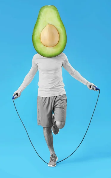 Sporty Man Ripe Avocado Instead His Head Jumping Rope Blue — стоковое фото