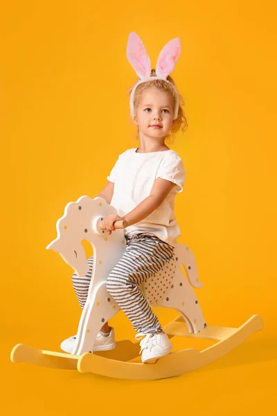 Cute Little Girl Bunny Ears Rocking Horse Yellow Background — Stock Photo, Image