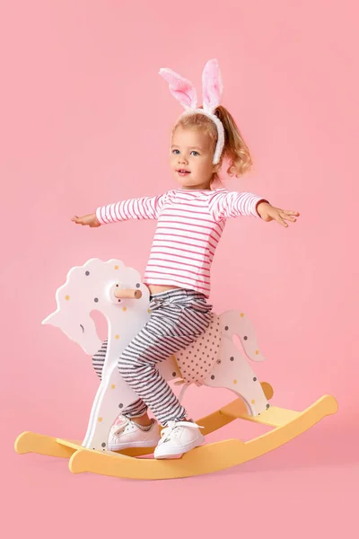 Adorable Little Girl Bunny Ears Rocking Horse Pink Background — 图库照片