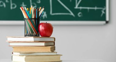 Sınıfta elma, kitap ve okul kırtasiyesi