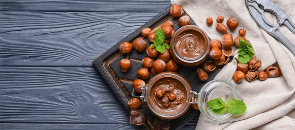 Jars Tasty Chocolate Paste Hazelnuts Dark Wooden Background Top View — Stock Photo, Image