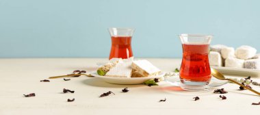 Tasty Turkish tea with sweets on white table