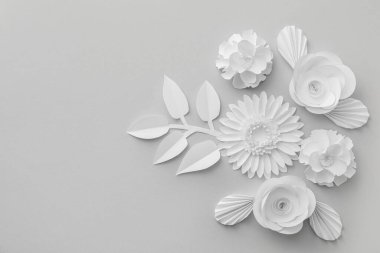 Composition with different paper flowers on grey background