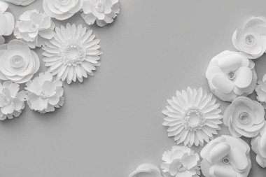 Composition with different paper flowers on grey background