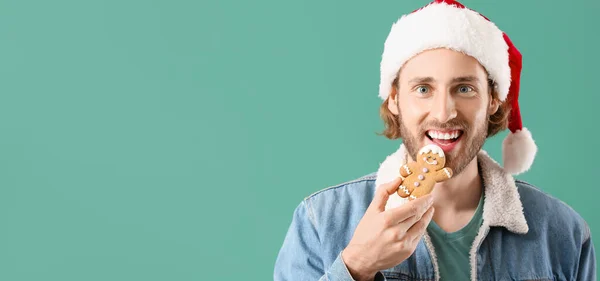 Handsome Man Santa Hat Eating Gingerbread Cookie Green Background Space — Stock Photo, Image
