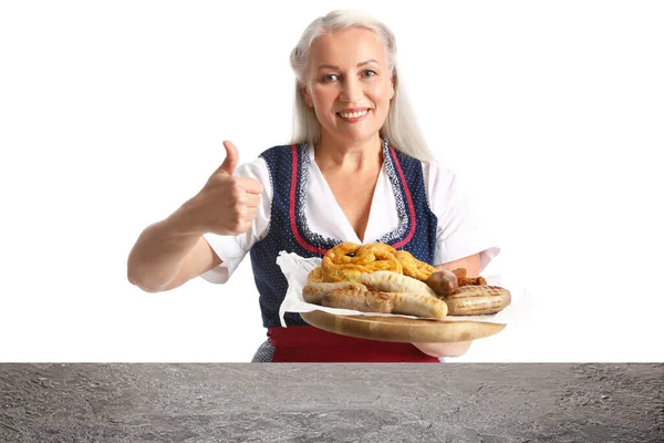 Mature Oktoberfest Waitress Holding Plate Snacks Showing Thumb Table White — 스톡 사진