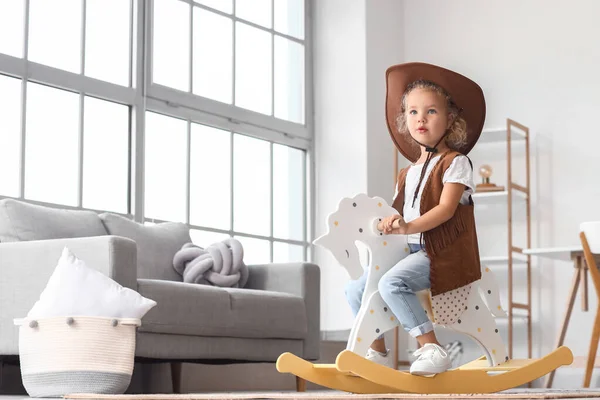 Little Girl Hat Vest Playing Rocking Horse Home — 图库照片