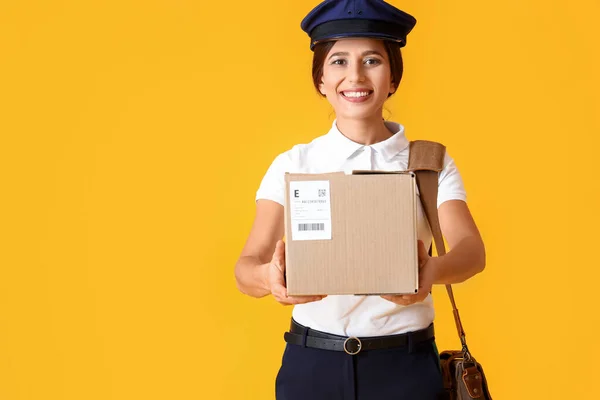 Young Postwoman Bag Parcel Yellow Background — Fotografia de Stock