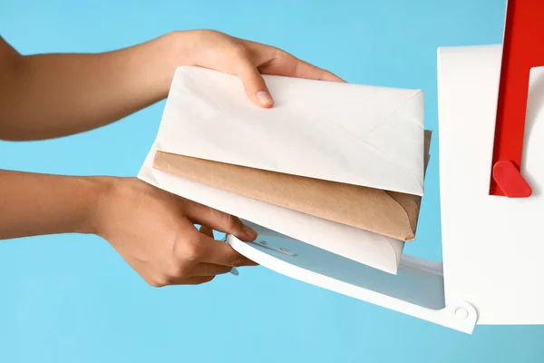 Young Postwoman Putting Letters Mailbox Blue Background Closeup — Foto Stock