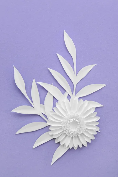 Beautiful origami flower and leaves on violet background