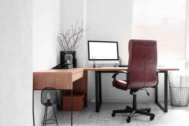 Modern workplace with chair in light office