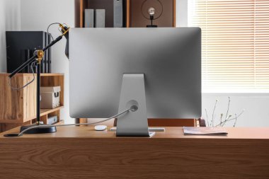 Modern ofiste bilgisayar ve lambalı işyeri