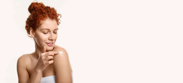 Beautiful Redhead Woman Applying Body Cream White Background Space Text — Foto de Stock
