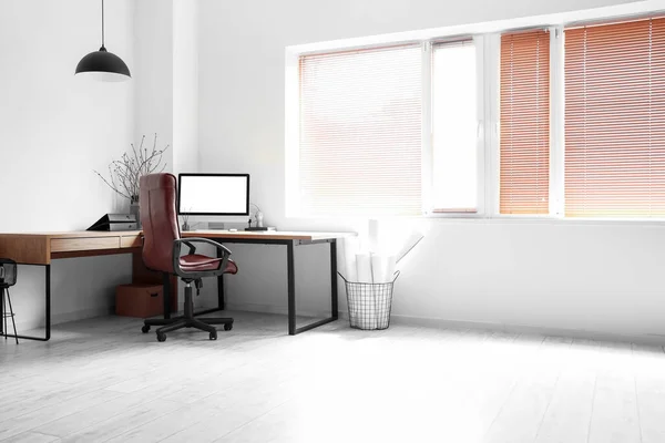 Modern workplace with chair in light office