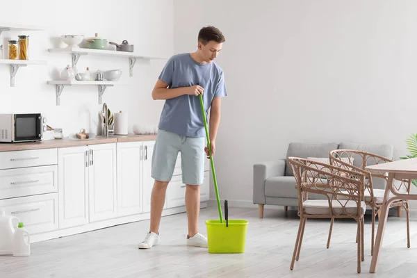 Handsome Young Man Mopping Floor Modern Kitchen — стоковое фото