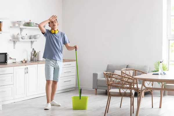 Tired Young Man Mopping Floor Kitchen —  Fotos de Stock