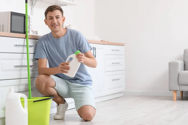 Young Man Bottle Detergent Kitchen —  Fotos de Stock