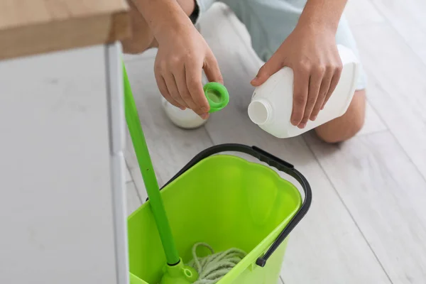 Young Man Pouring Detergent Bucket Kitchen Closeup — Foto de Stock