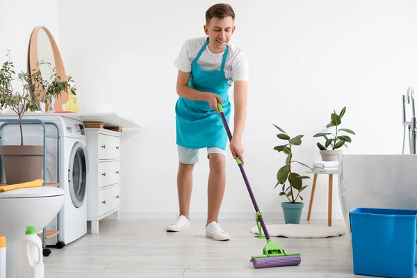 Young Man Mopping Floor Modern Bathroom — 图库照片