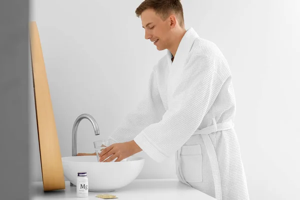 Young Man Filling Glass Water Bathroom — Foto de Stock