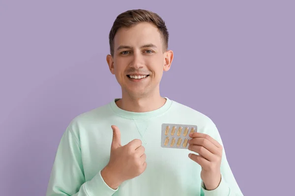 Young Man Blister Pills Showing Thumb Violet Background — Φωτογραφία Αρχείου