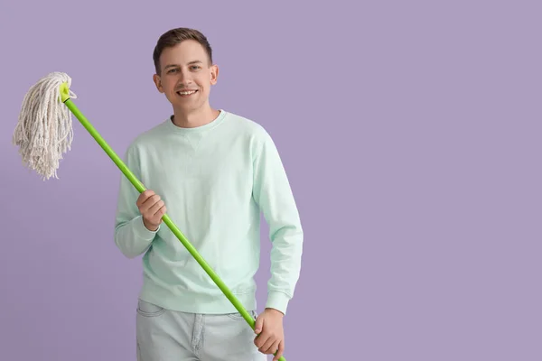 Young Man Mop Violet Background — Stockfoto