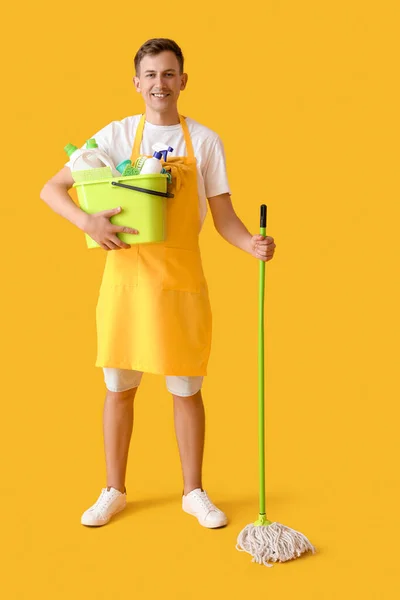 Smiling Young Man Cleaning Supplies Yellow Background — Stock Photo, Image