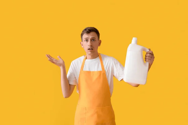 Upset Young Man Bottle Detergent Yellow Background — Fotografia de Stock