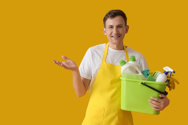 Young Man Holding Bucket Cleaning Supplies Yellow Background — Stock Photo, Image